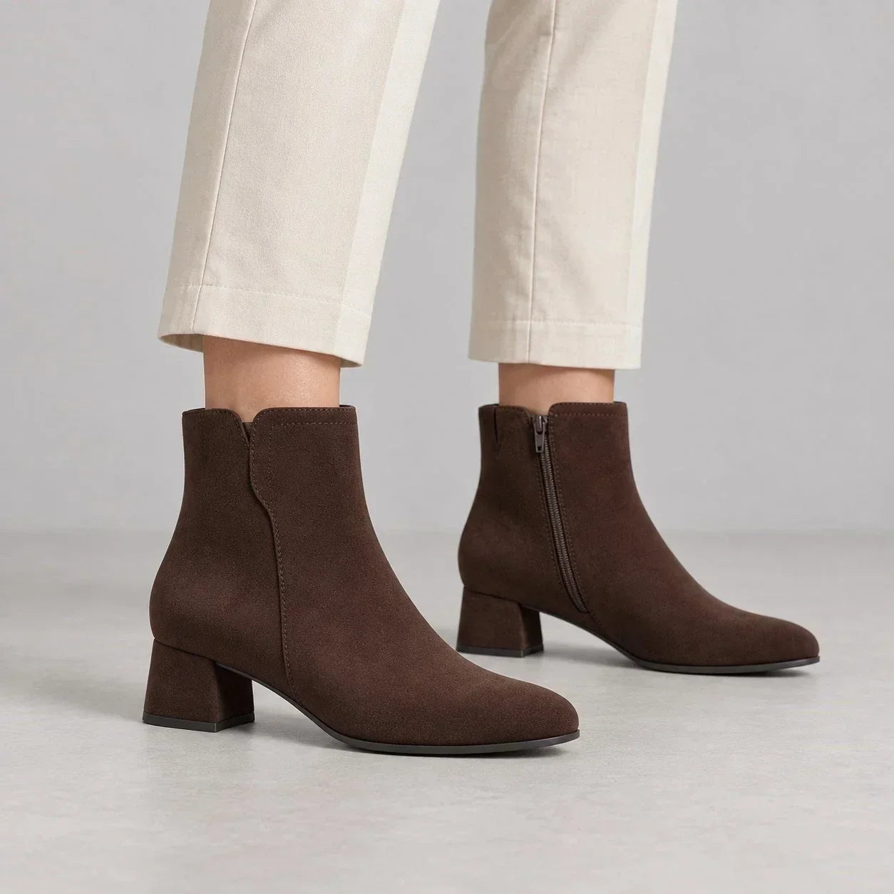 Jana brown suede-effect wide-fit ankle boots worn with cream trousers