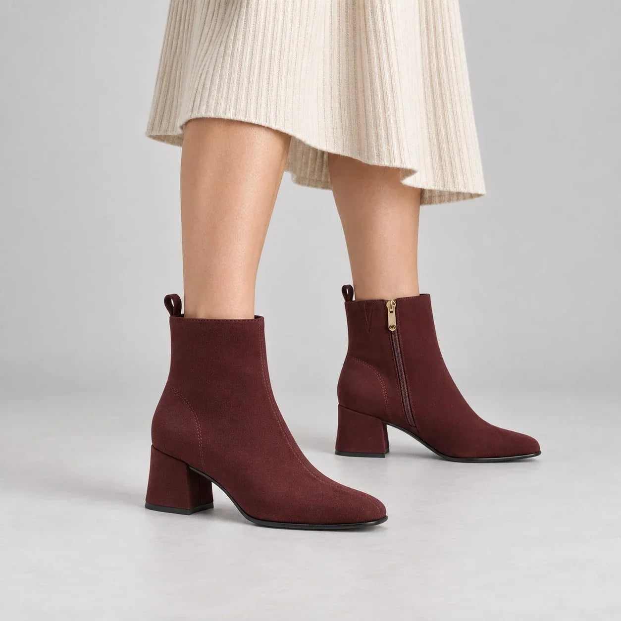 Marco Tozzi burgundy suede-effect block heel ankle boots styled with a cream knitted dress