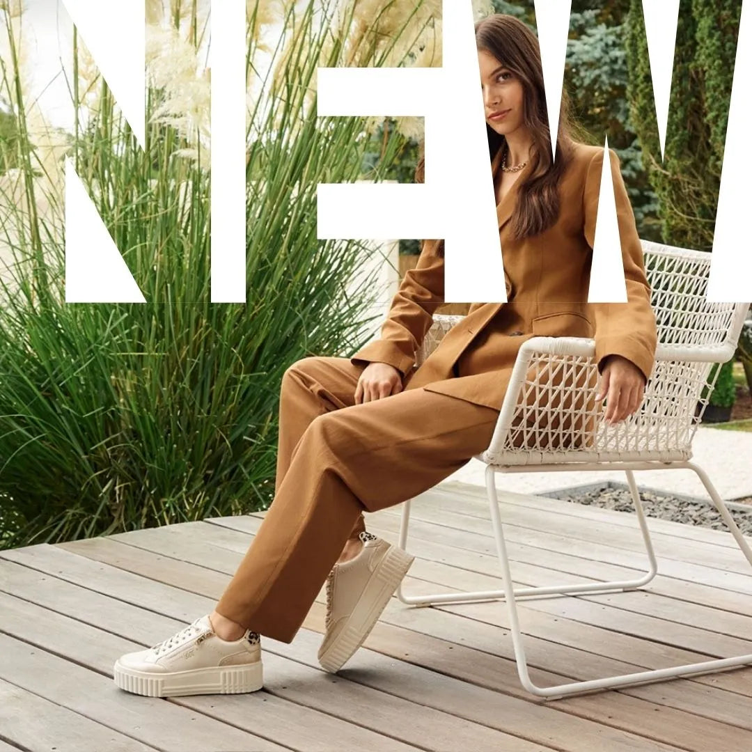 Woman wearing brown jumpsuit with dressy trainers.