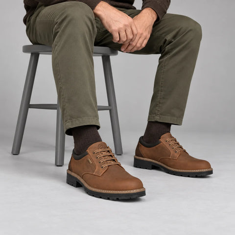 Ara Frederick men's brown GORE-TEX lace-up shoes worn with olive chinos and brown socks in a grey studio.