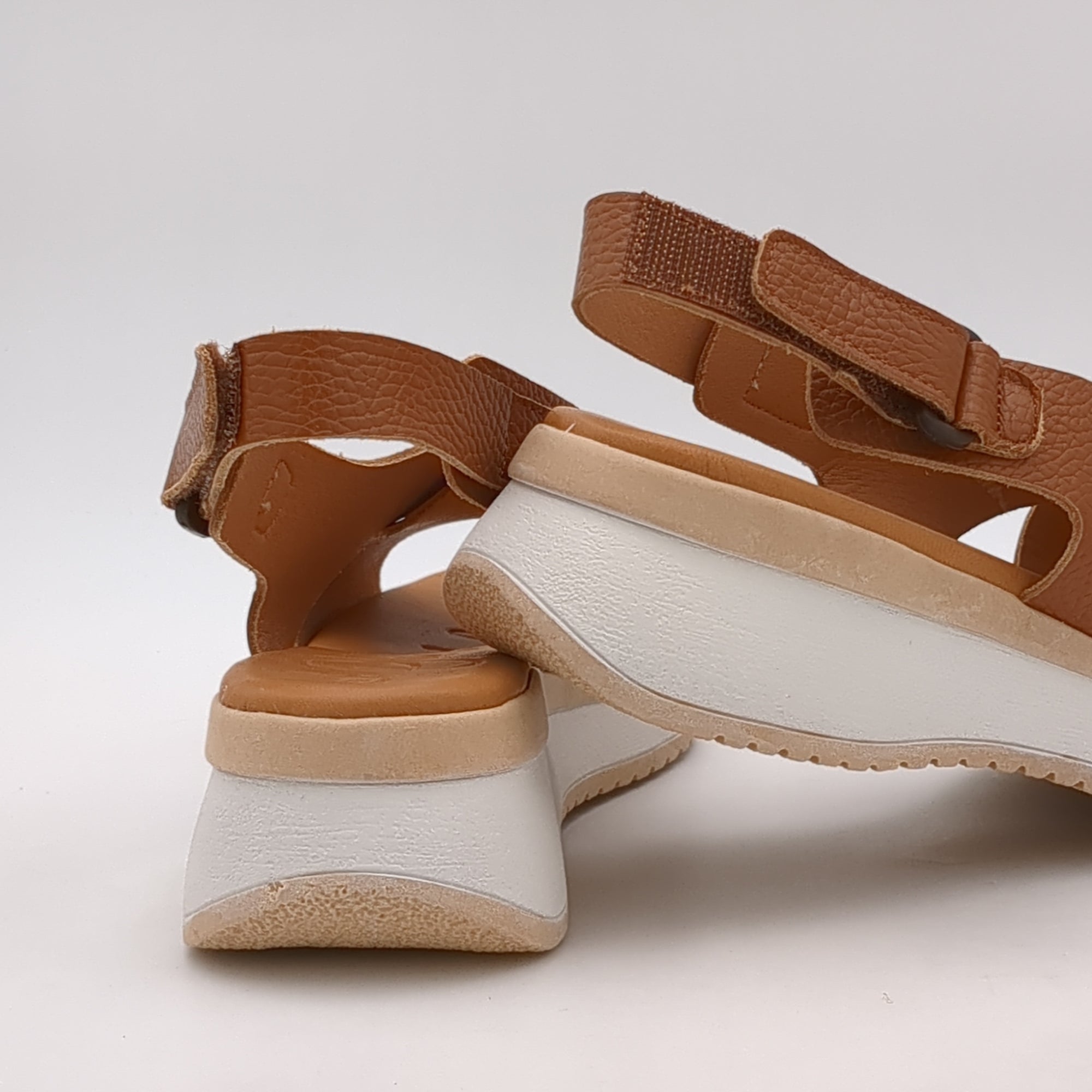 Lifestyle image of the sandals worn at a casual outdoor event, demonstrating their versatility and stylish design.