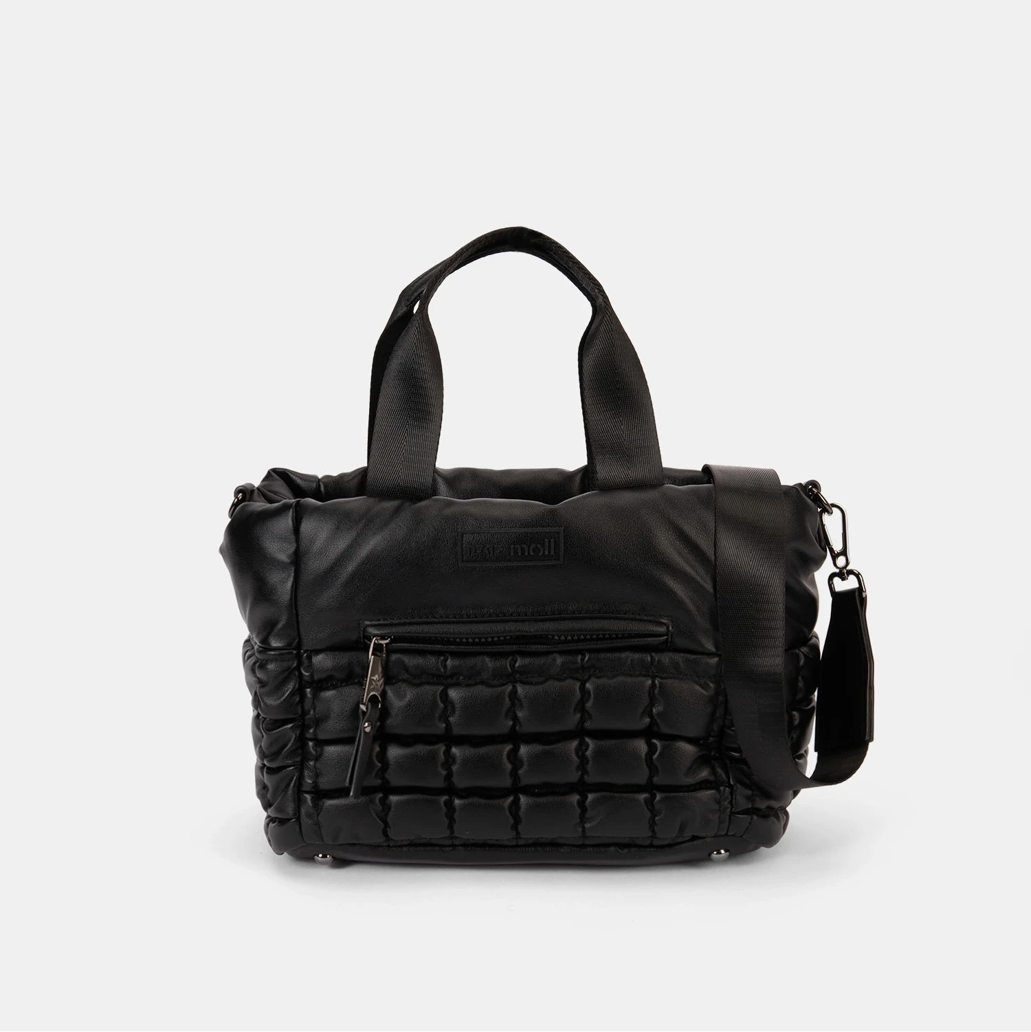 Black quilted handbag on a light gray background