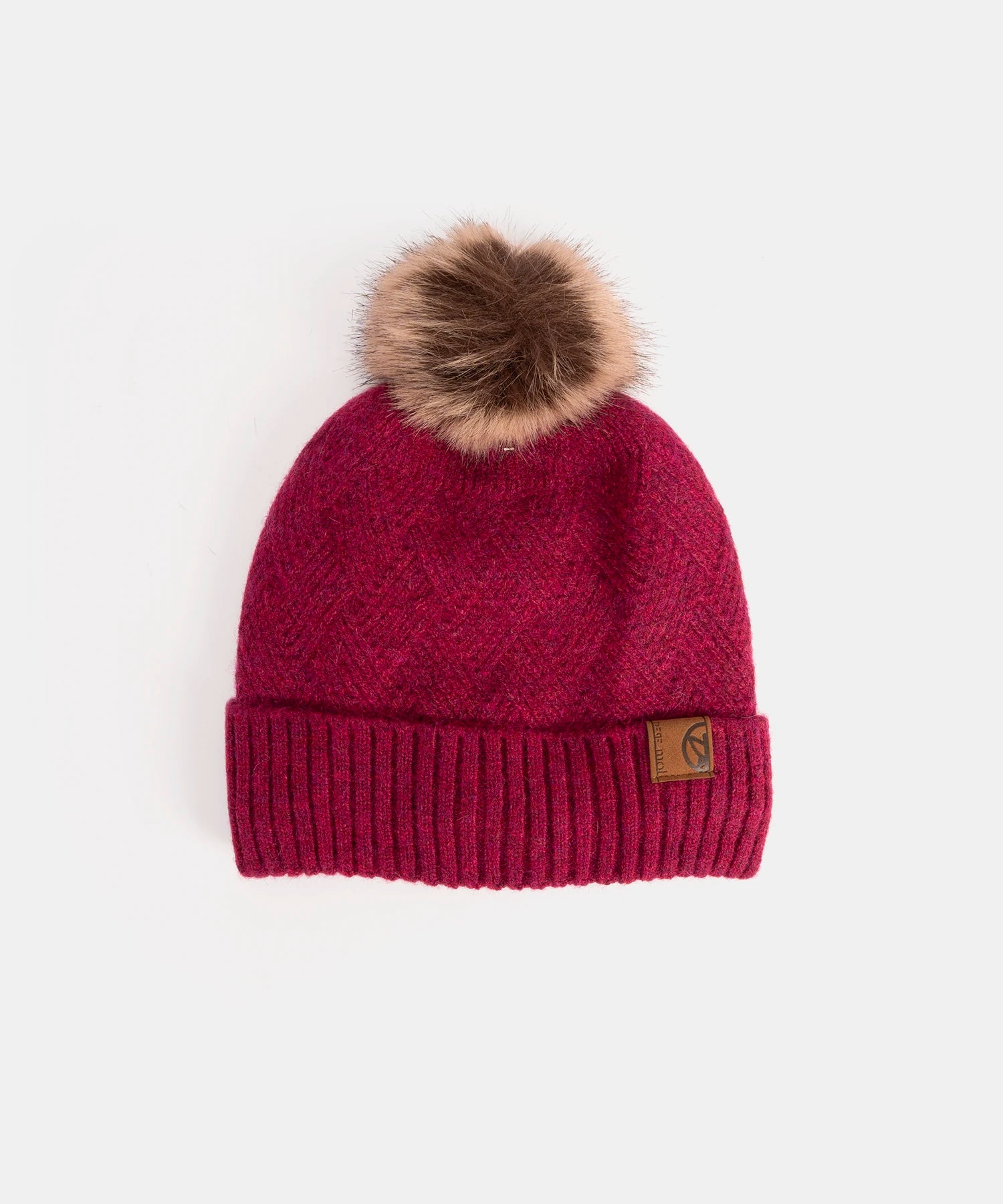 Red knit beanie with a fur pom-pom on a white background