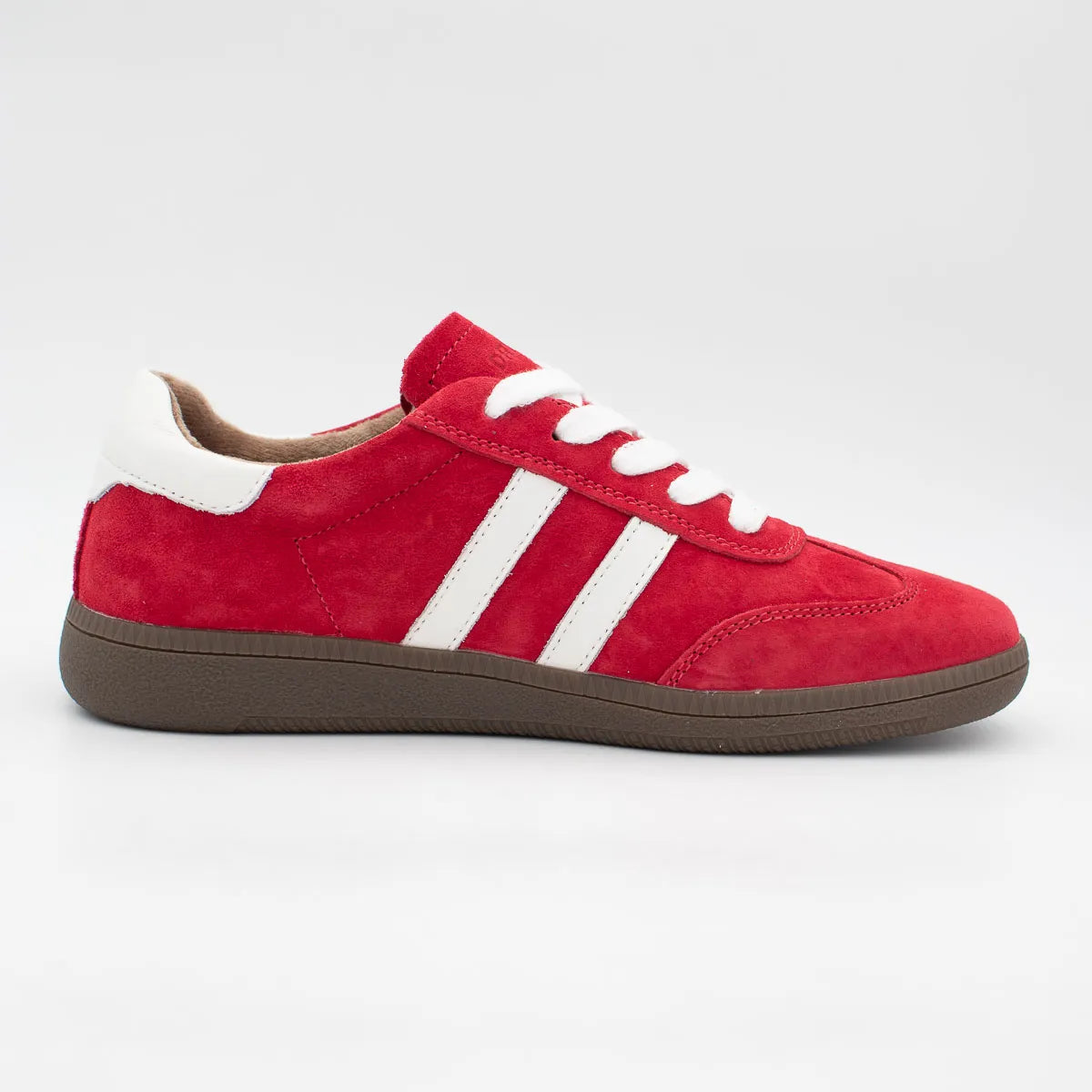 Red sneaker with white stripes on a light gray background