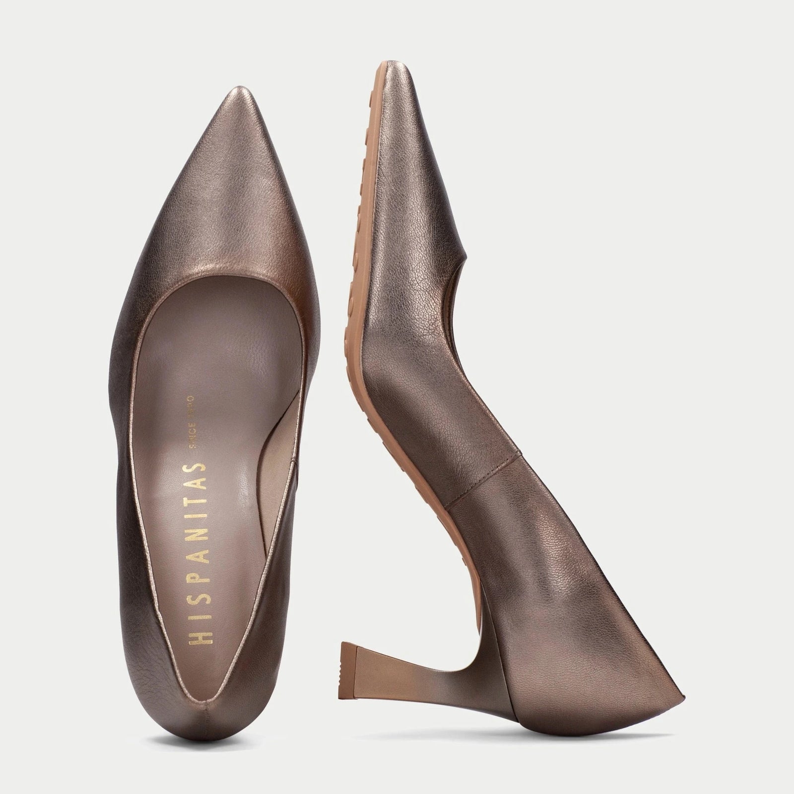Pair of brown high-heeled shoes on a light gray background