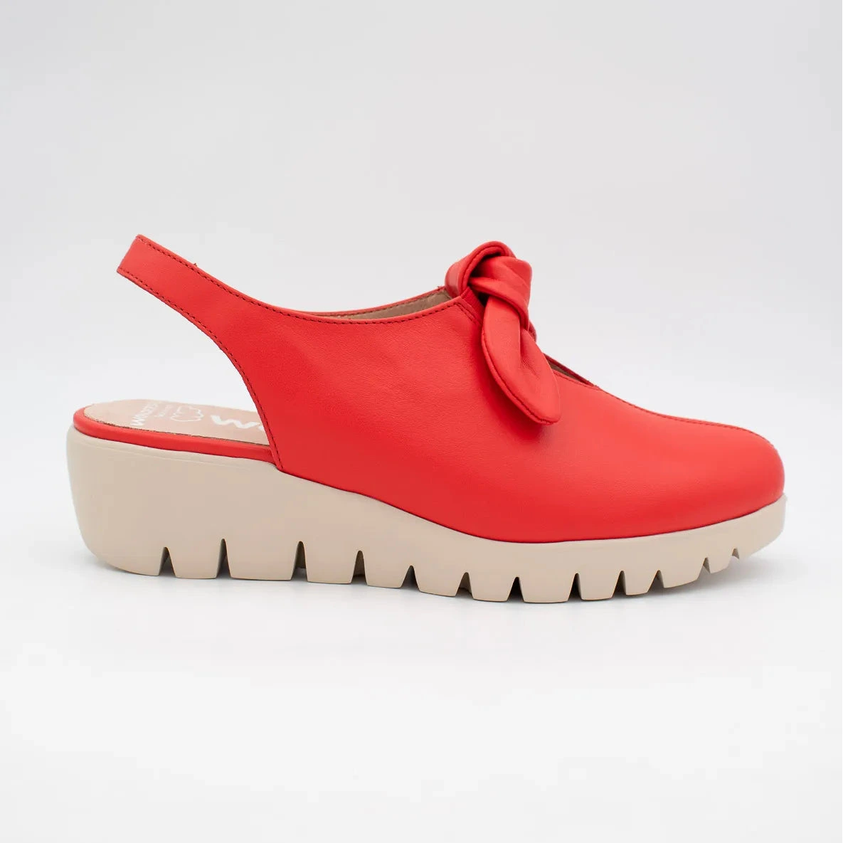 Red clog shoe with a bow on a white background