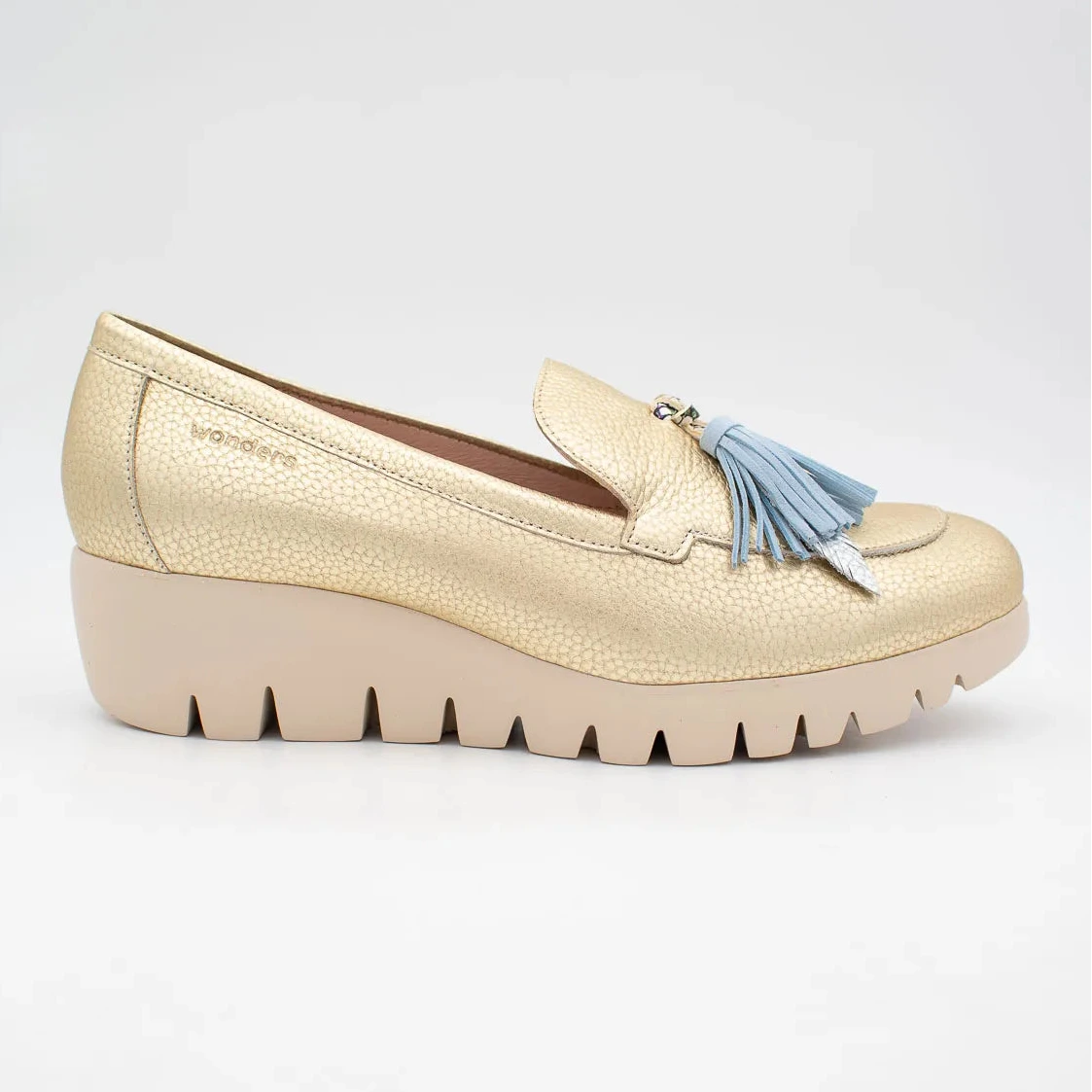 Gold loafer with a blue tassel on a white background