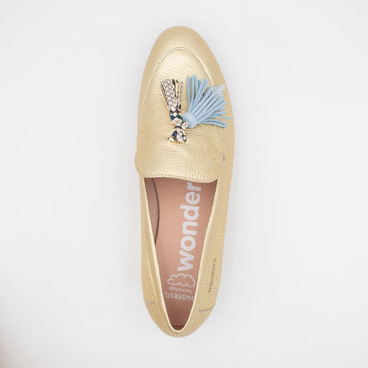 Gold loafer with a blue tassel and charm on a white background