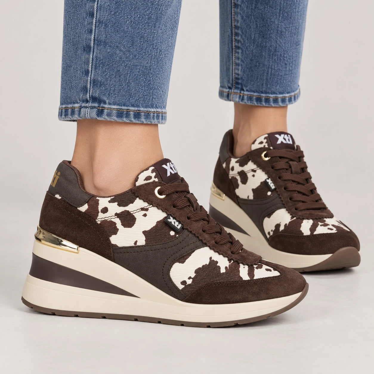 Xti Chocolate Brown Cow Print Wedge Trainers