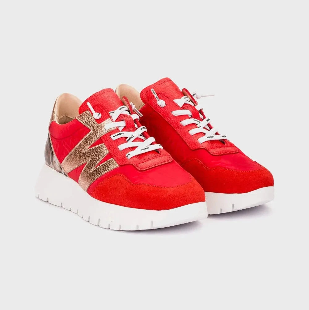 Red sneakers with white laces on a light gray background