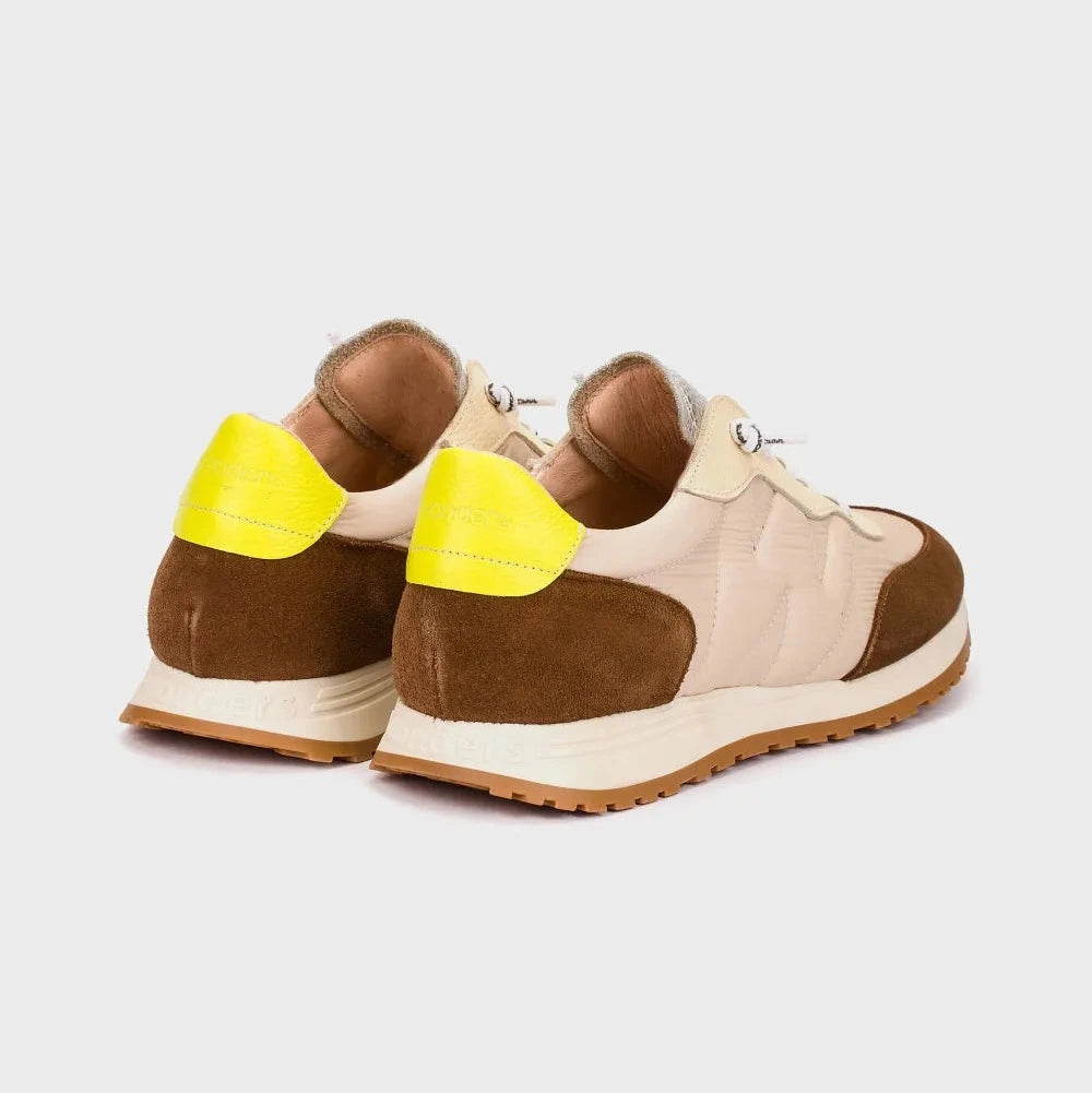 Pair of brown and beige sneakers with yellow accents on a light gray background