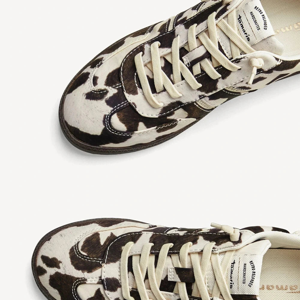 Pair of black and white patterned sneakers on a white background
