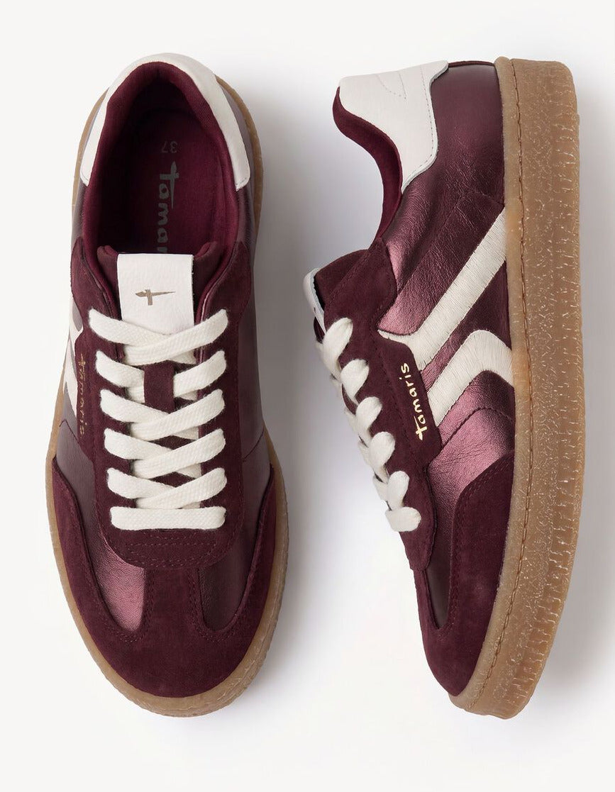 A pair of vintage-style low-top sneakers shown from top and side views on a clean white background. The shoes feature a metallic burgundy upper with white side stripes, white laces, and a brown gum sole.