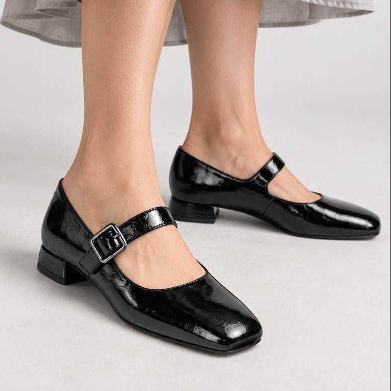 Unisa Culver black patent Mary Jane shoes worn with a grey midi skirt