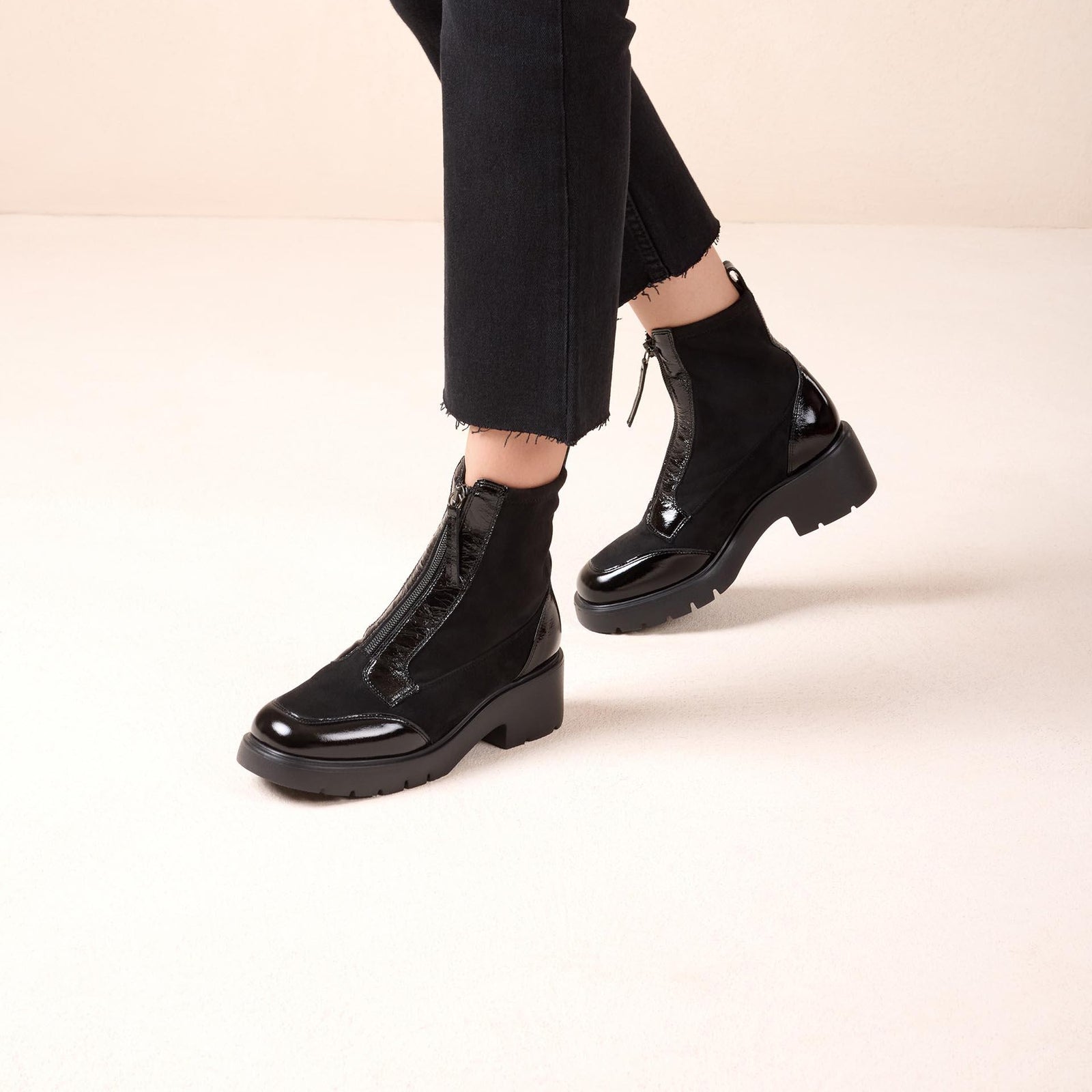 Unisa Jandro black patent and stretch zip ankle boots worn with cropped black trousers
