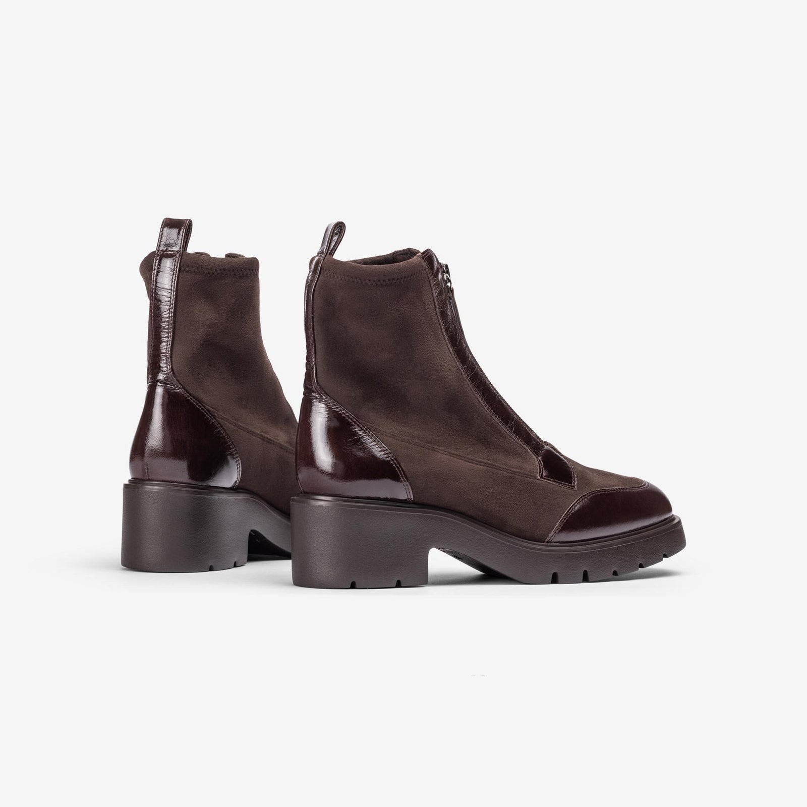 Unisa Jandro dark brown stretch and patent ankle boots showing rear pull tabs, patent heel panels and treaded soles