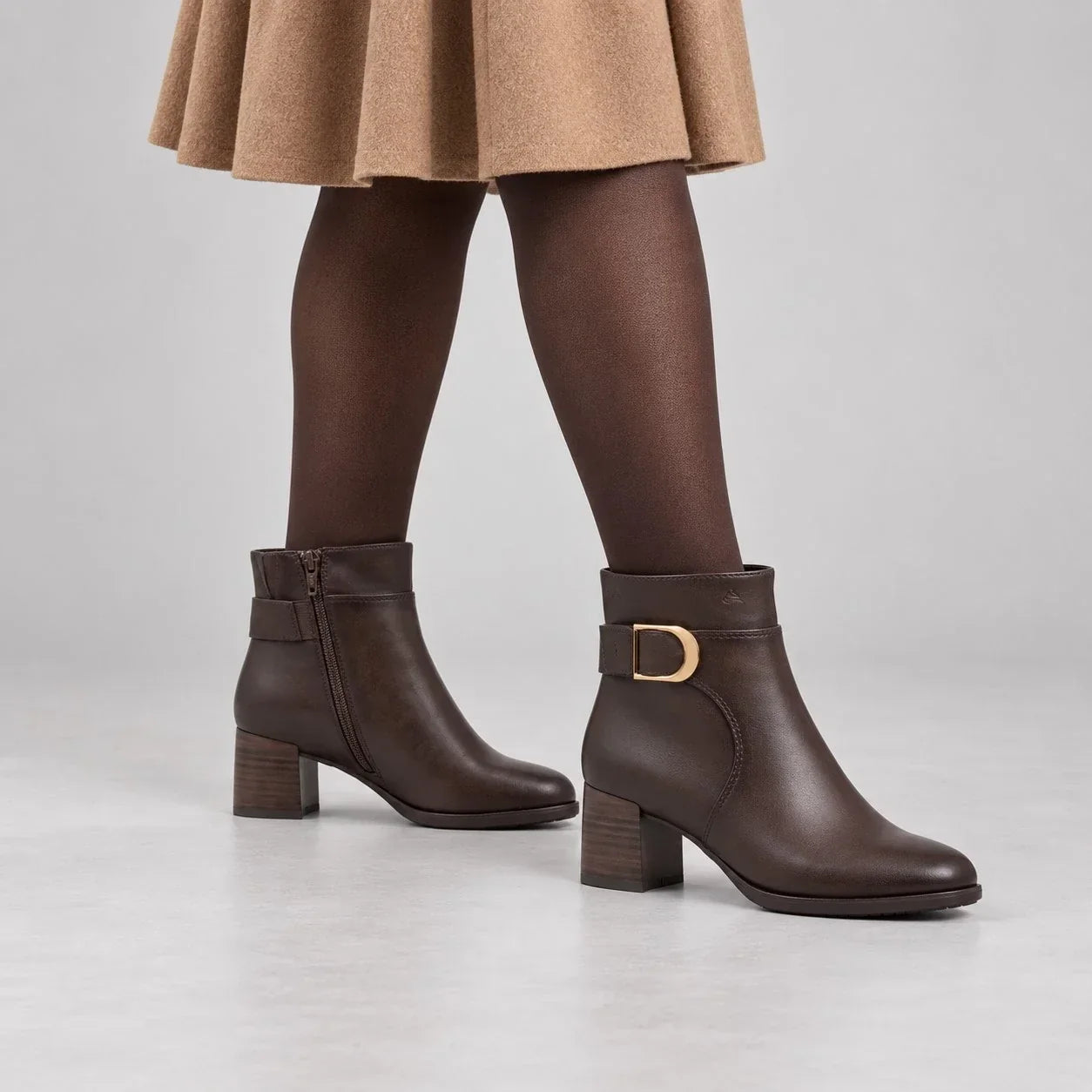 Jana chocolate brown ankle boots with gold-tone buckles, worn with brown tights and a camel skirt