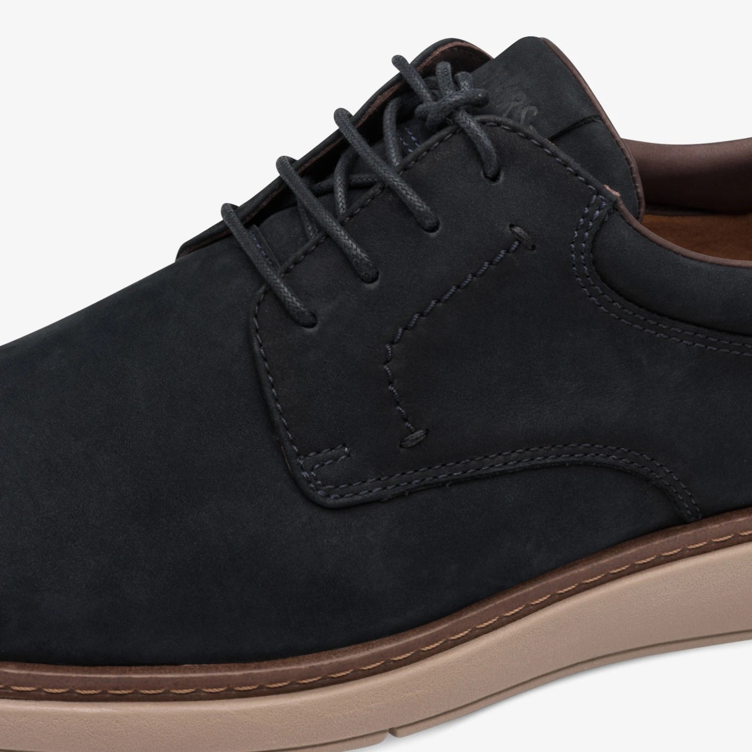 Close-up of the lacing, navy leather and brown trim on the Tamaris men's shoe.