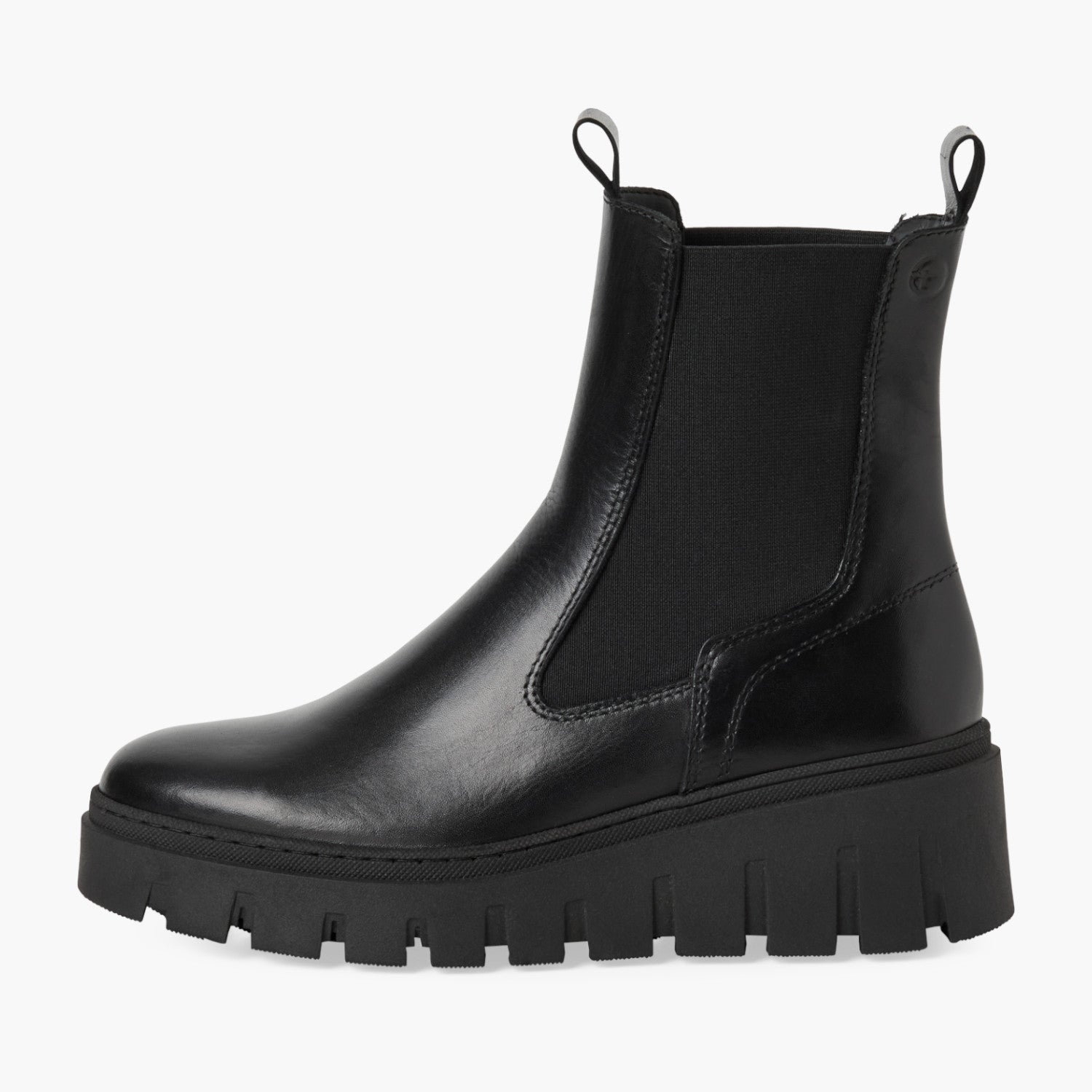 Black chunky boots worn with blue jeans on a white background