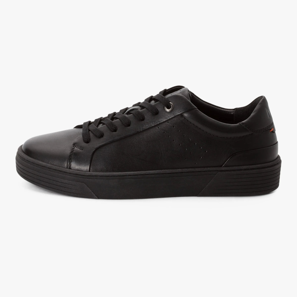 Outer side of the Marco Tozzi men's black leather trainer, showing the subtle perforations.
