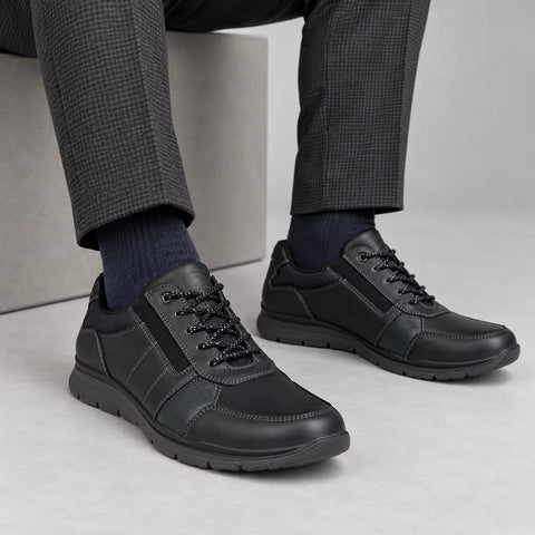 Ara Benjo men's navy leather lace-up shoes styled with charcoal trousers and navy socks in a grey studio.