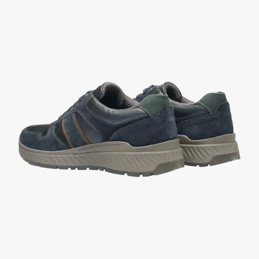 Pair of blue casual shoes with beige soles on a white background