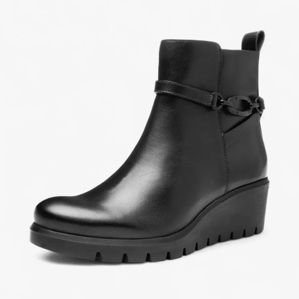 Black leather ankle boot with a wedge sole on a white background
