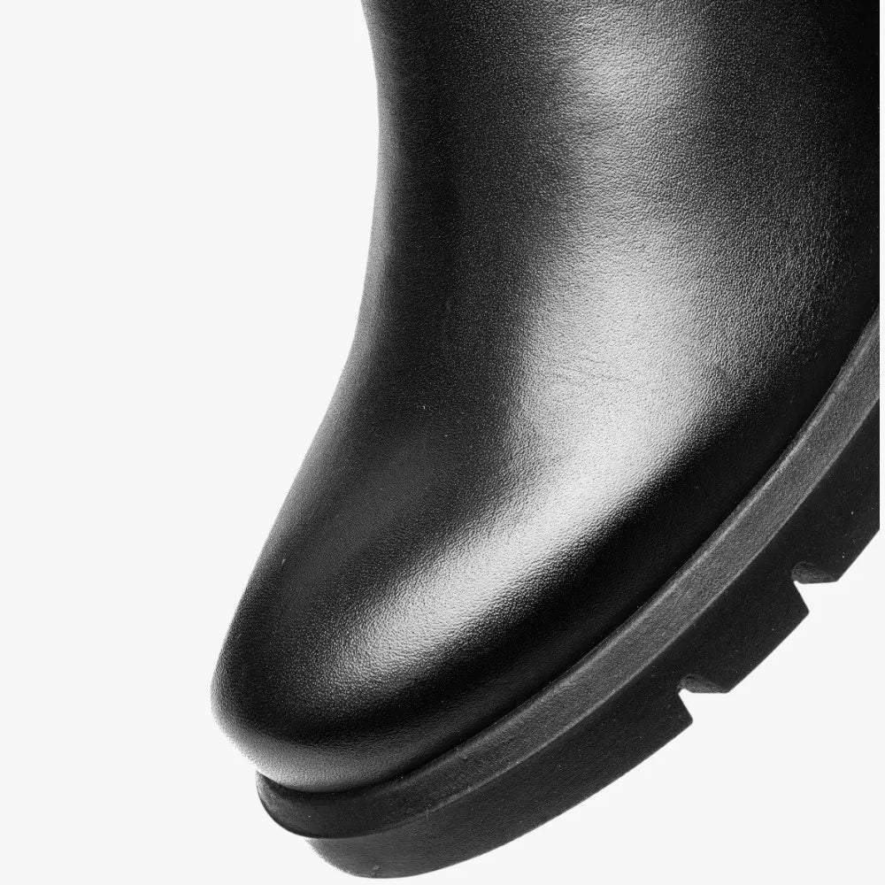 Close-up of a black leather boot sole on a white background