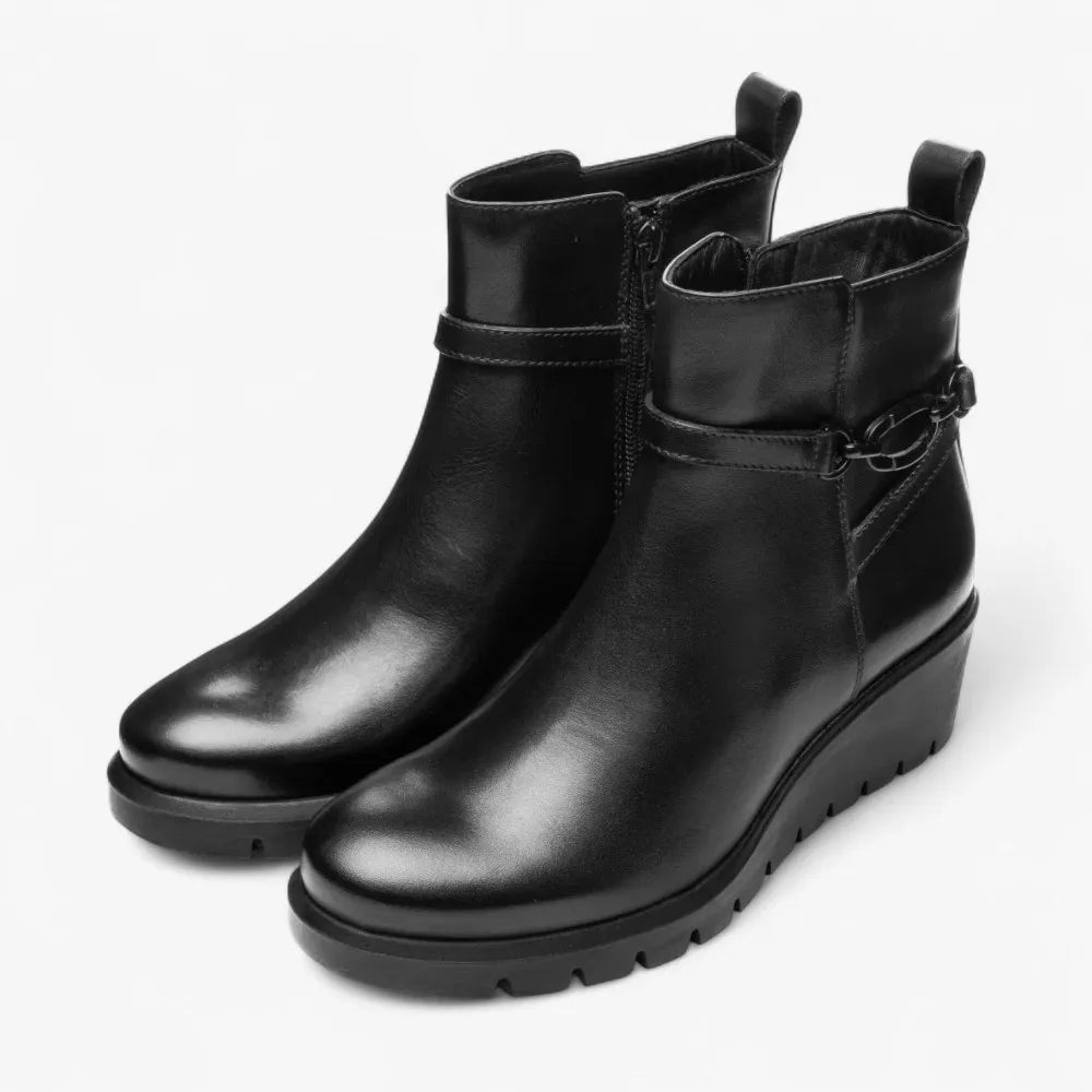 Pair of black leather ankle boots on a white background