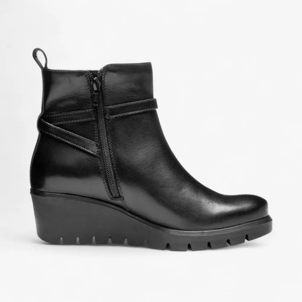 Black wedge ankle boot on a light gray background
