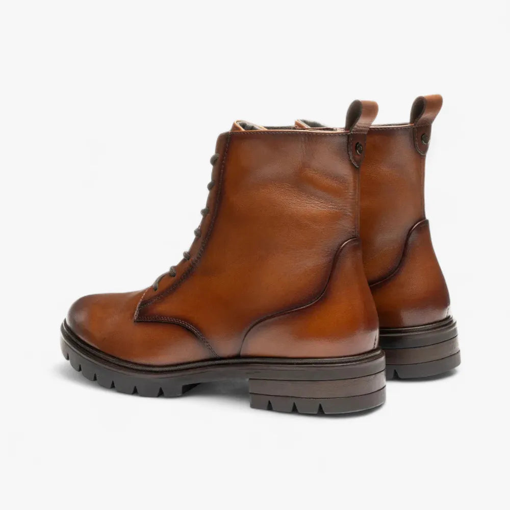 Pair of brown leather boots on a white background