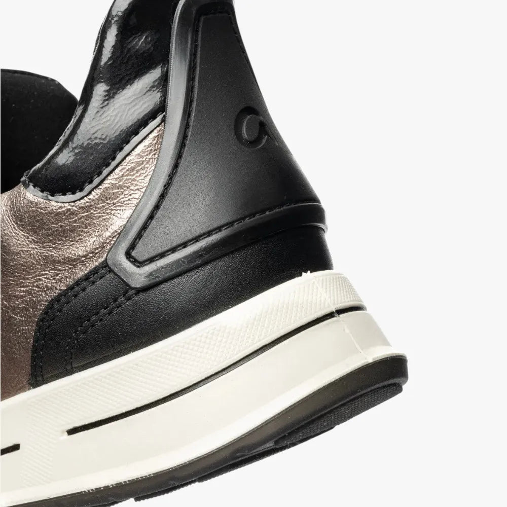 Close-up of a black and brown shoe with a white sole on a light gray background