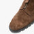 Brown suede shoe with a gold zipper on a white background