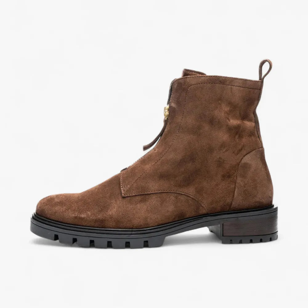 Brown suede boot with a black sole on a white background