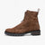 Brown suede boot with a black sole on a white background