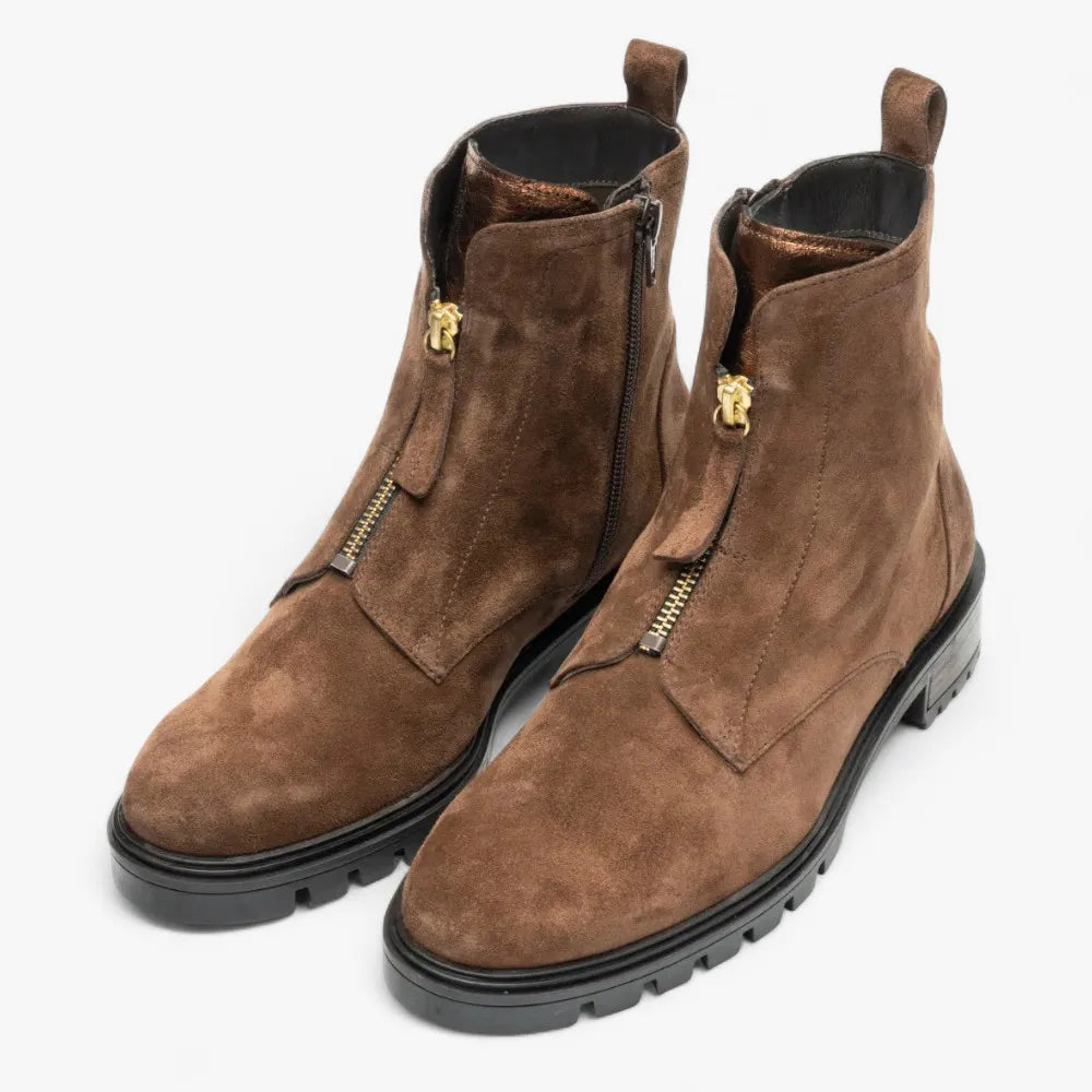 Pair of brown suede boots with gold zippers on a white background