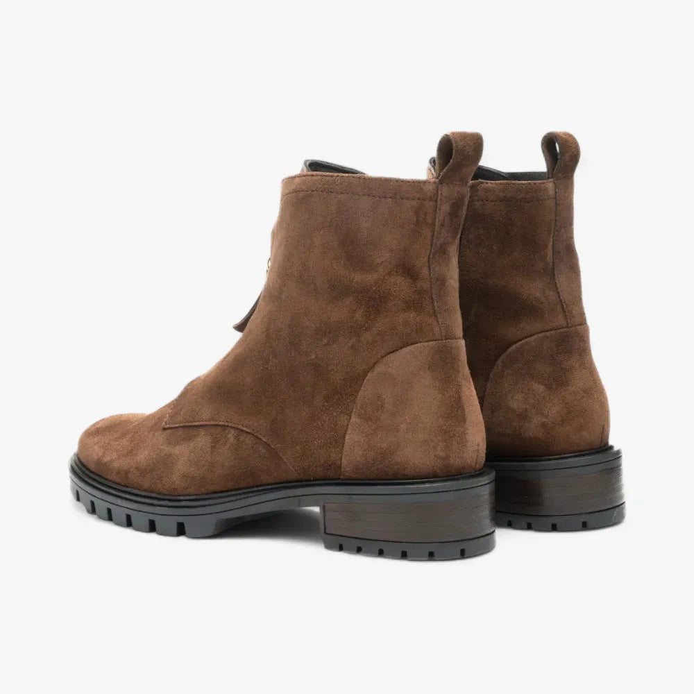 Pair of brown suede boots on a white background