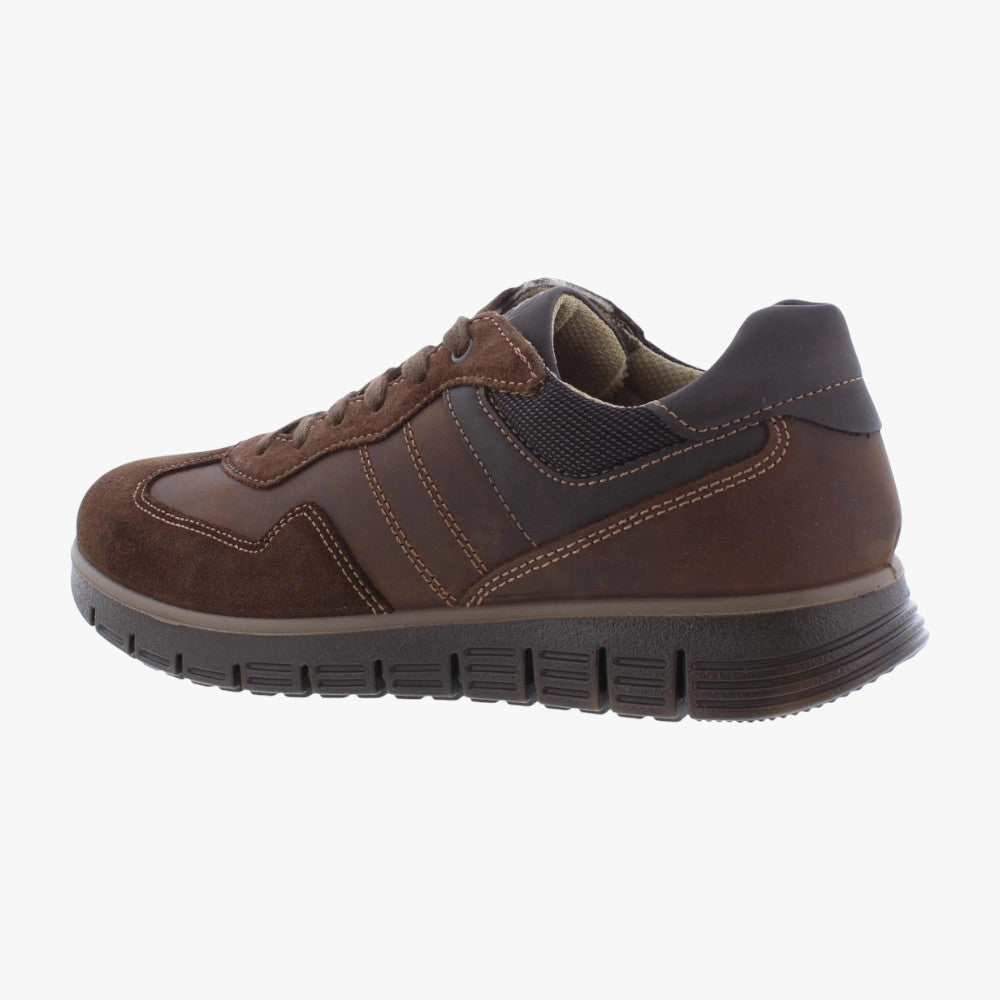 Brown sneaker with black sole on a white background