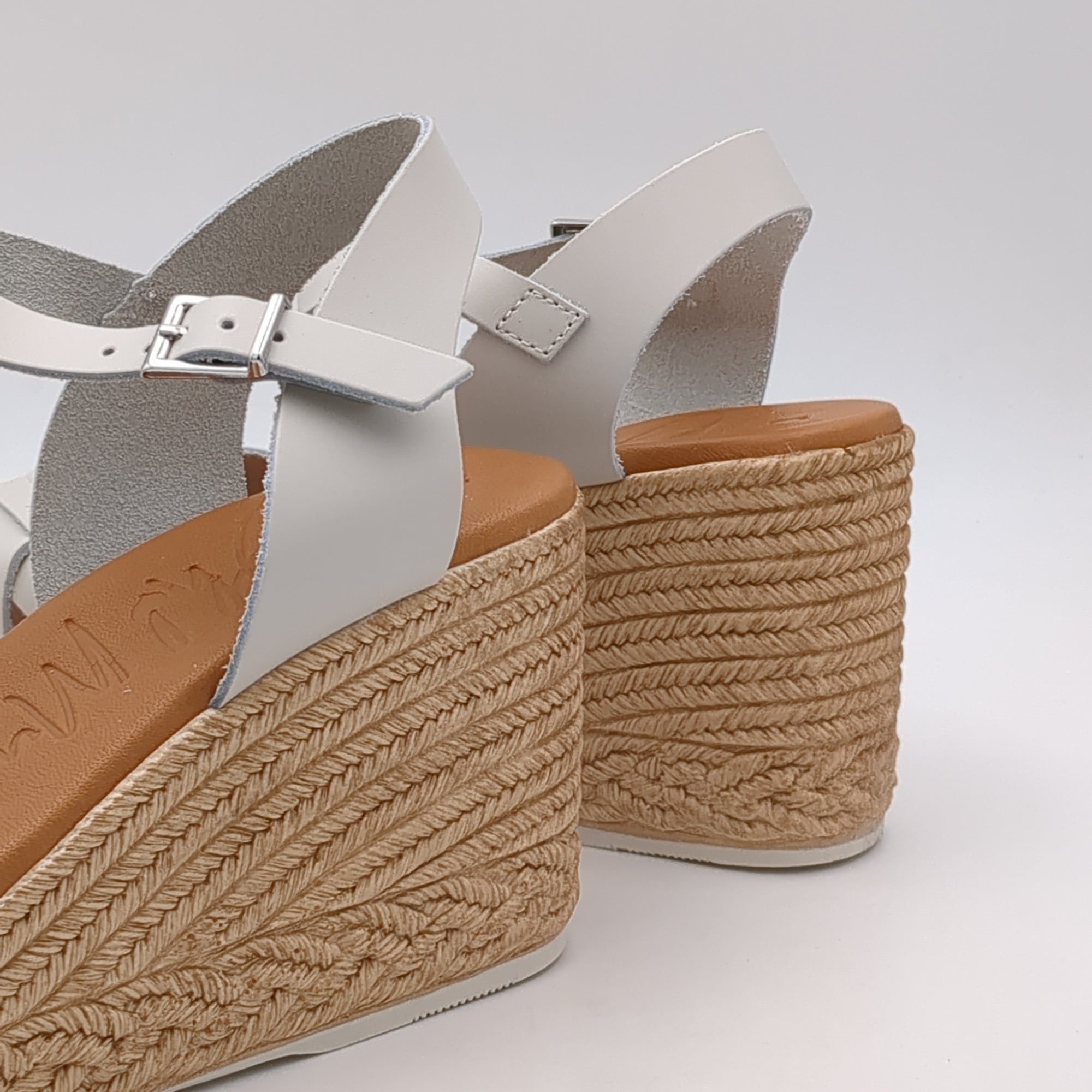 Full view of the sandal showcasing the square toe and neutral cream upper.
