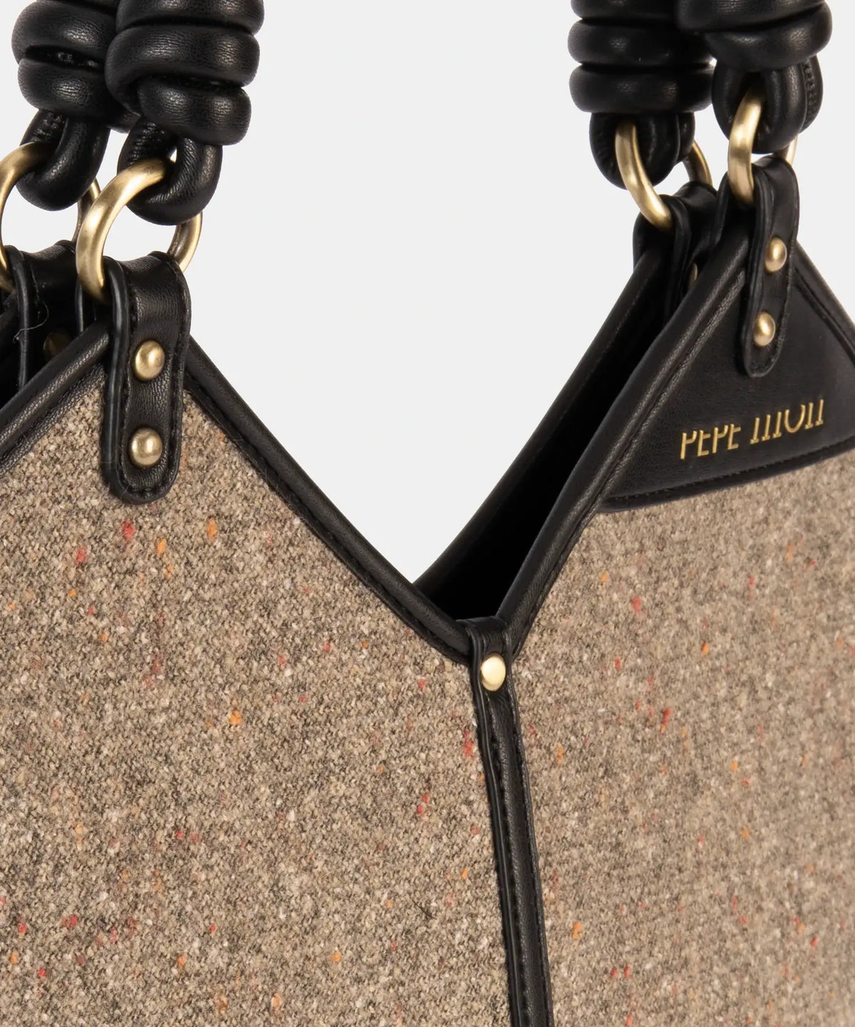Close-up of a textured handbag with black accents and 'Pepe Jeans' branding.