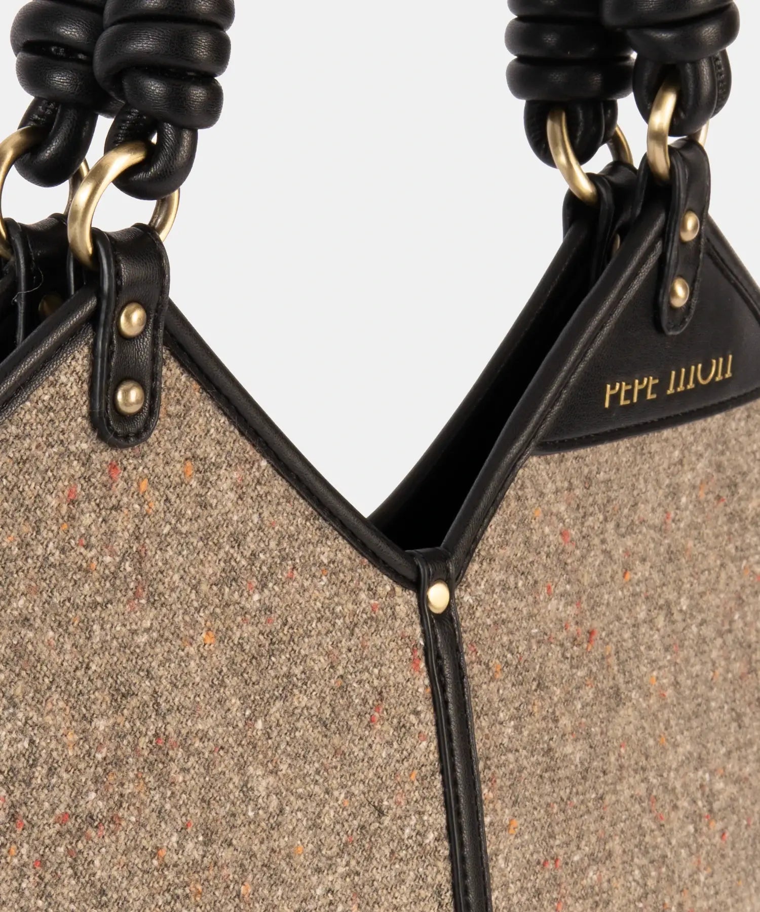 Close-up of a textured handbag with black accents and 'Pepe Jeans' branding.