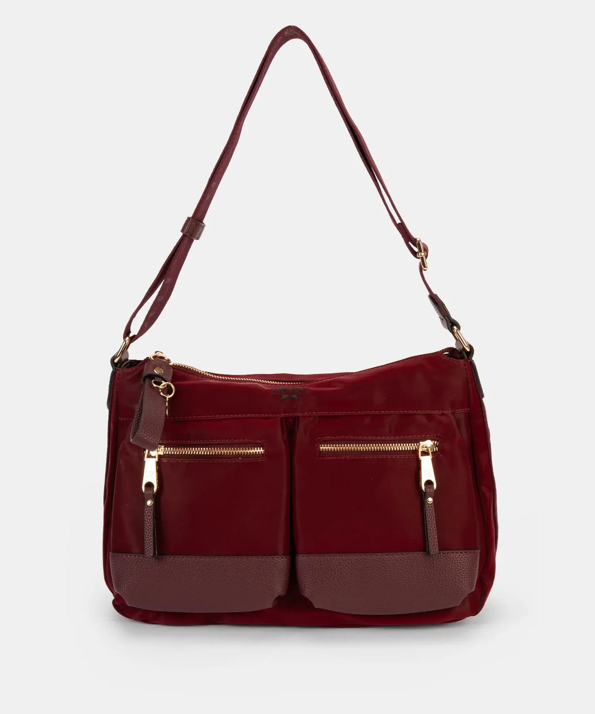 Red handbag with gold zippers on a light gray background