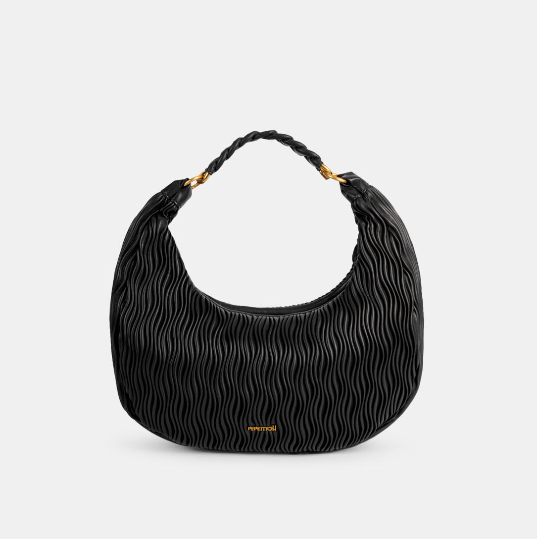 Black textured handbag with braided handle on a light gray background