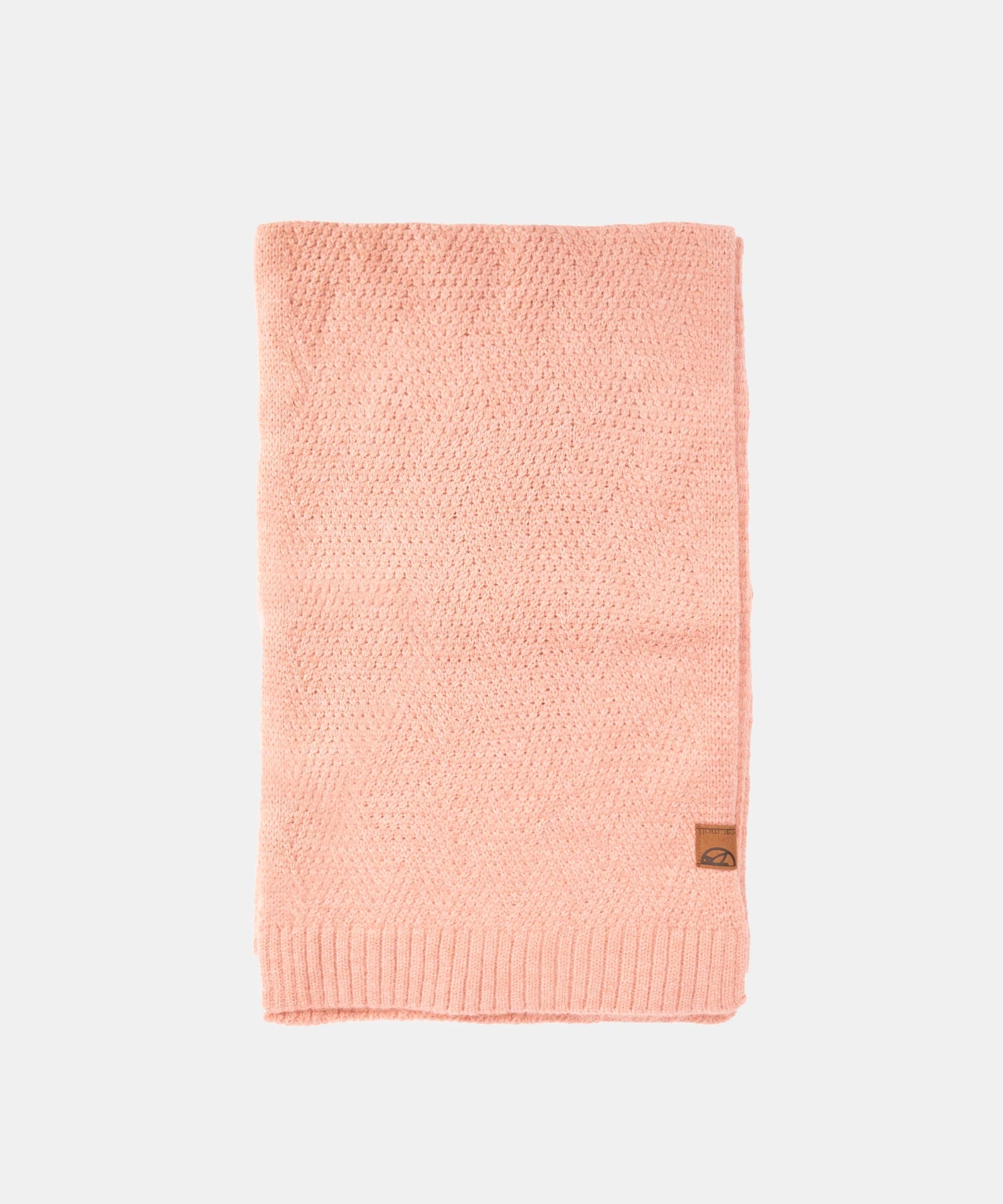 Pink knitted blanket with a brand label on a white background