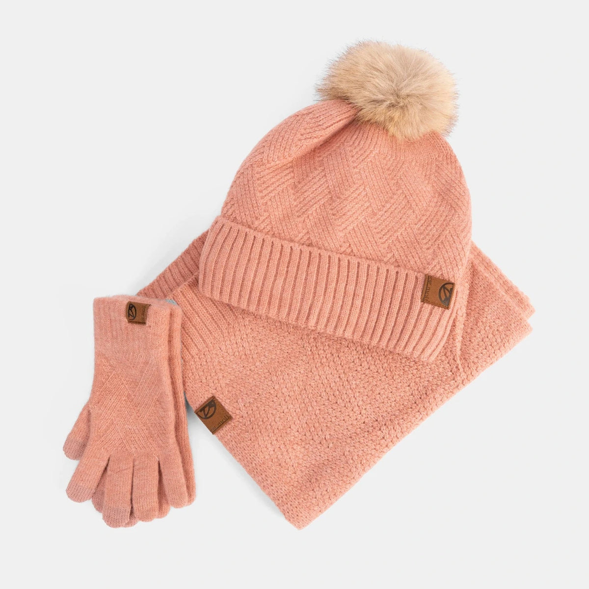 Pink knit hat and gloves set with pom-pom on a white background
