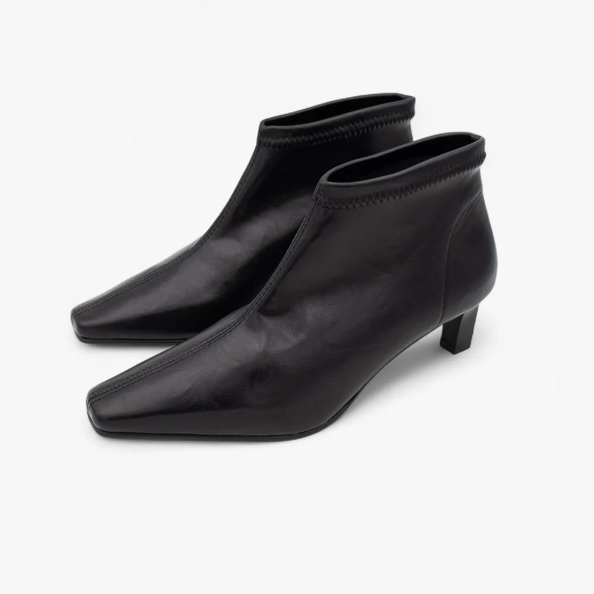 Pair of black ankle boots on a white background