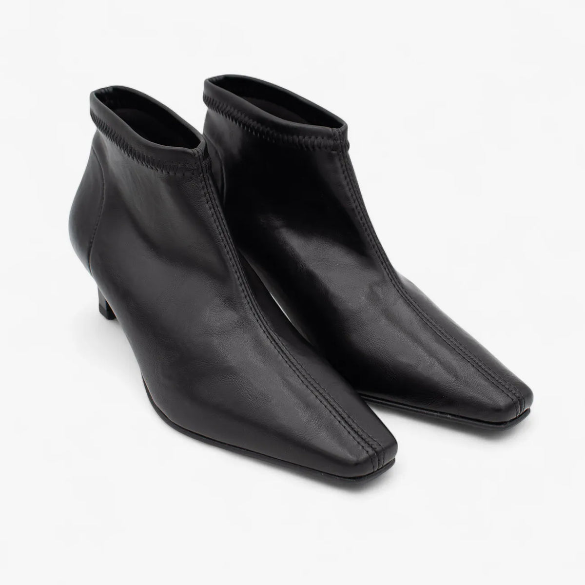 Pair of black ankle boots on a white background