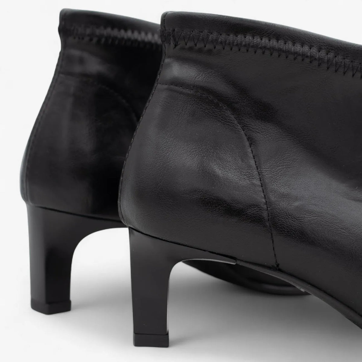 Black leather shoes with a slight heel on a white background