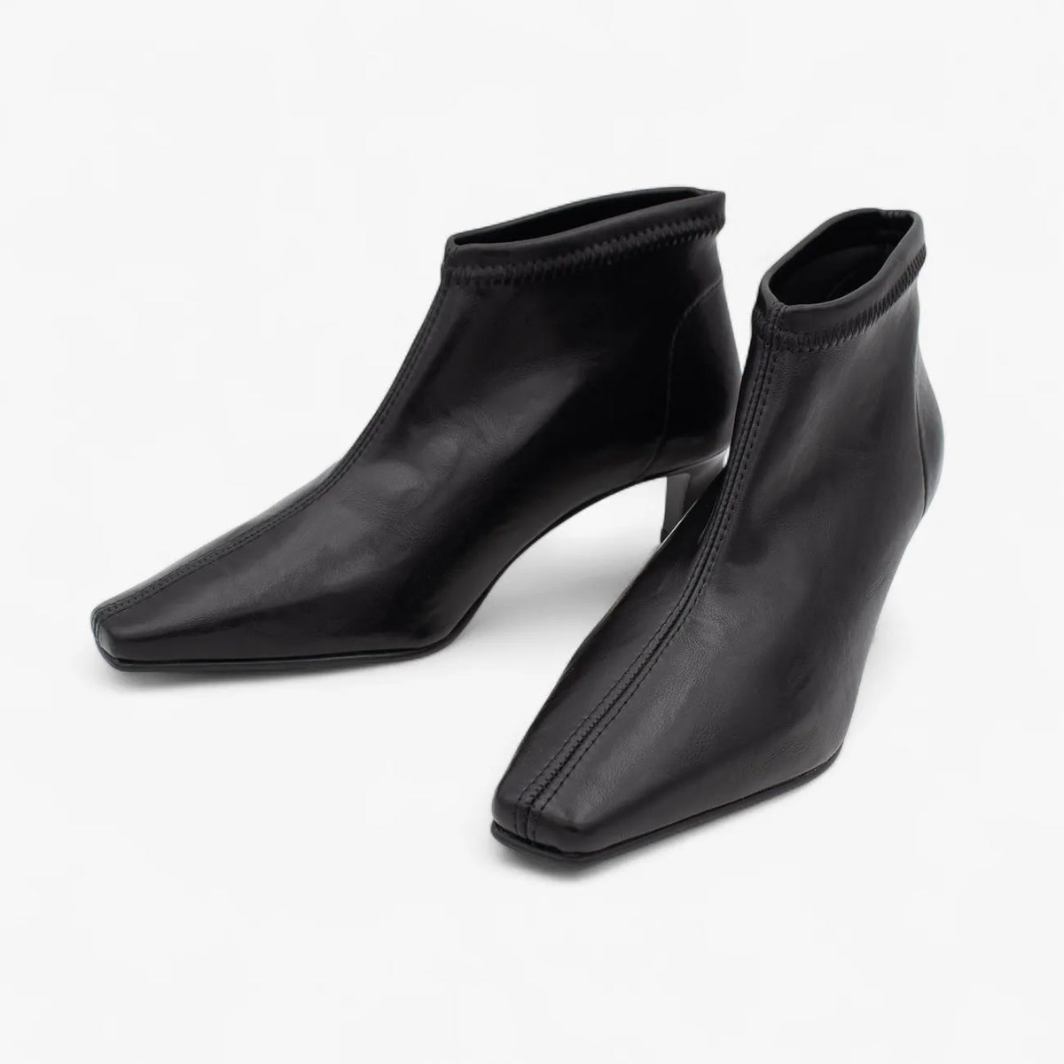 Pair of black ankle boots on a white background