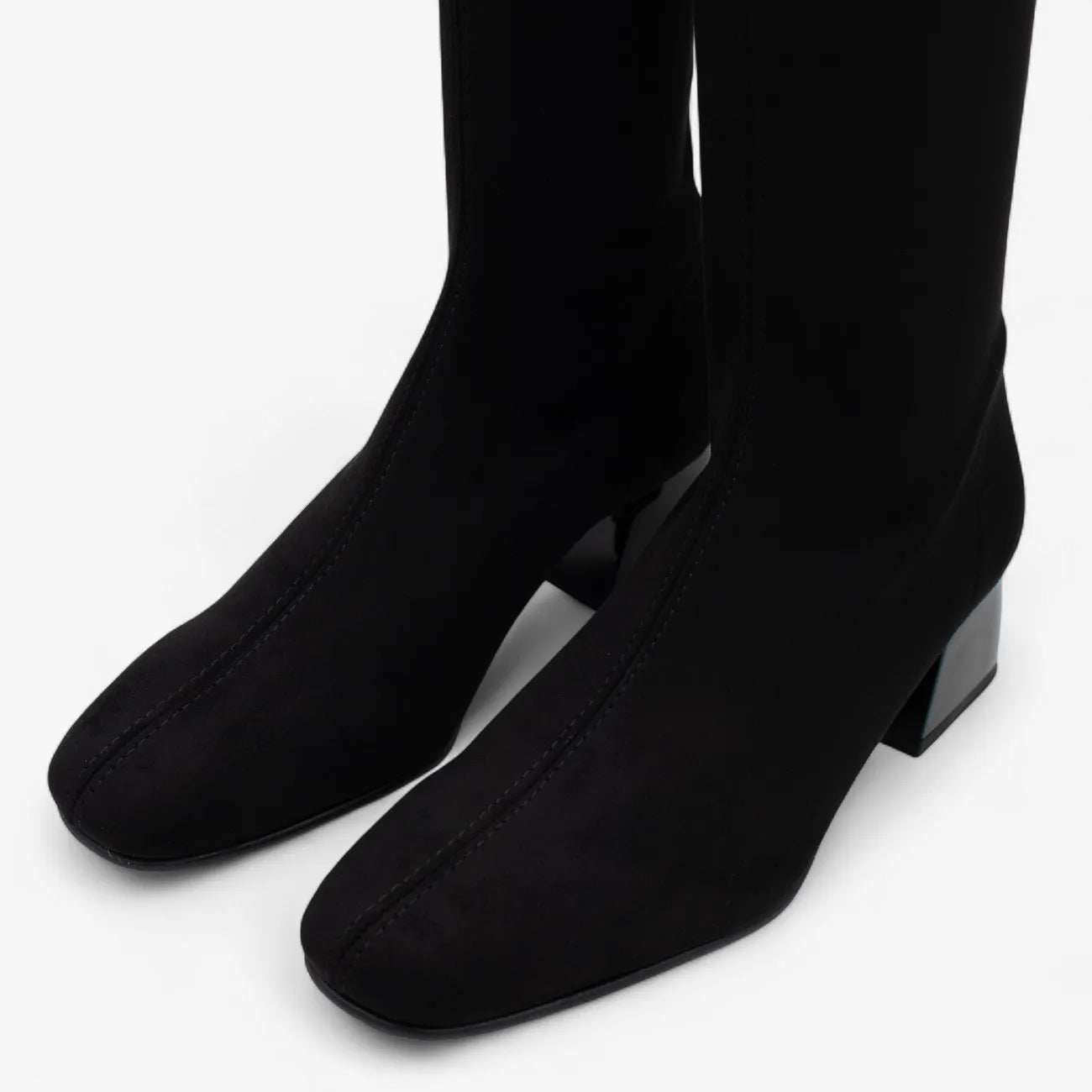 Black knee-high boots on a white background